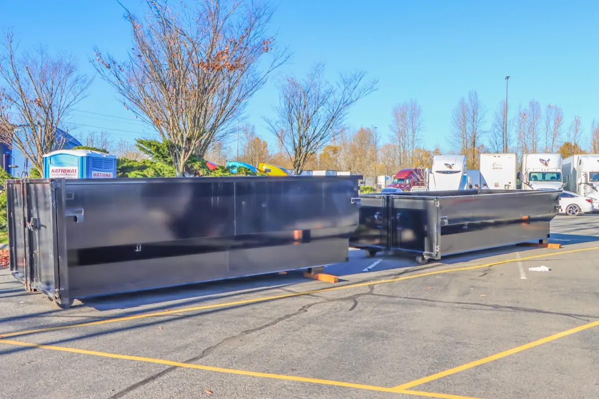 Professional dumpster rental service with roll-off container on residential driveway in Palm City